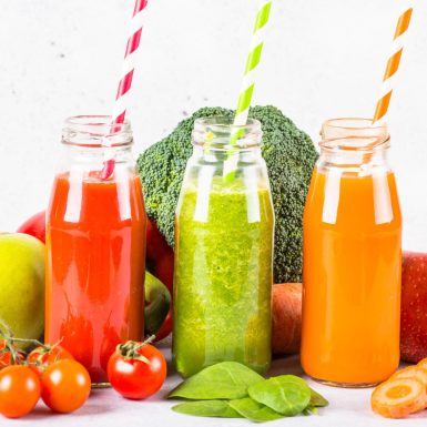 Fruit and Vegetable smoothie drink. Tomato, spinach and carrot fresh blended drink.
